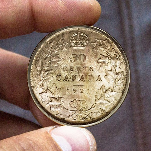 A person is holding 50 Canadian cent of 1921 year